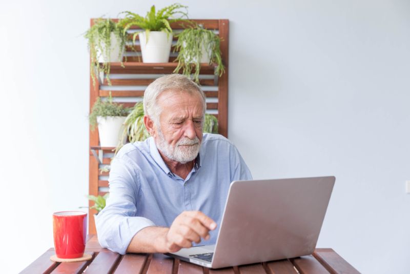 older man dealing with insurance dispute online