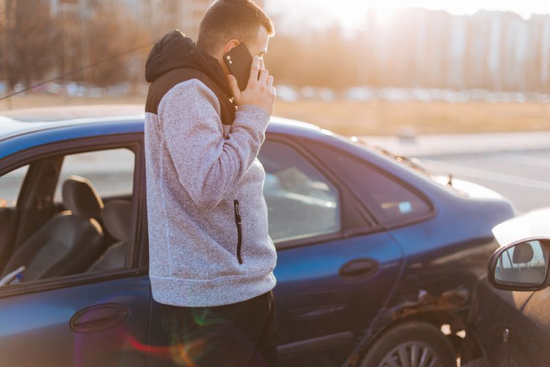 Man on a phone call after a car accident