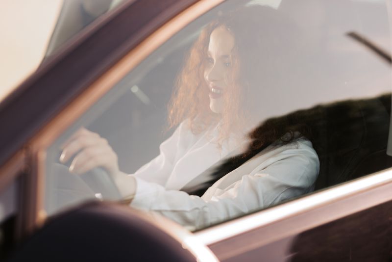 Woman driving alone during sunset
